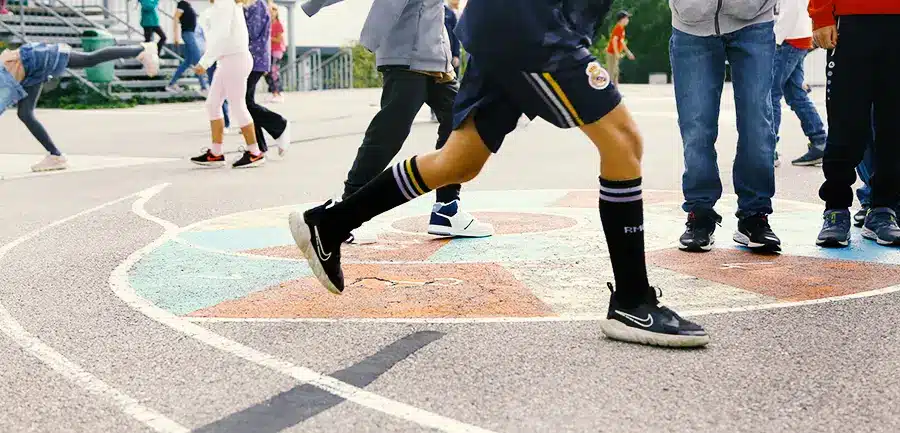 Schulkinder beewgen sich auf dem Pausenhof.